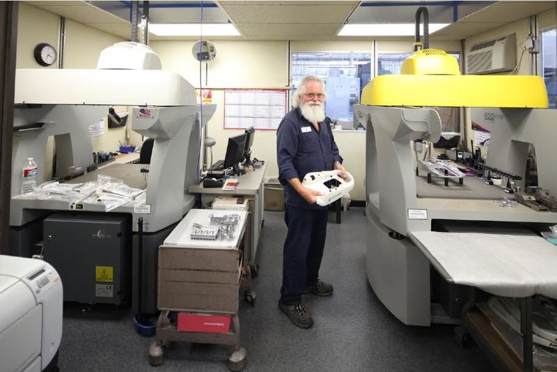 An SKS employee standing in the QC Metrology Lab at SKS